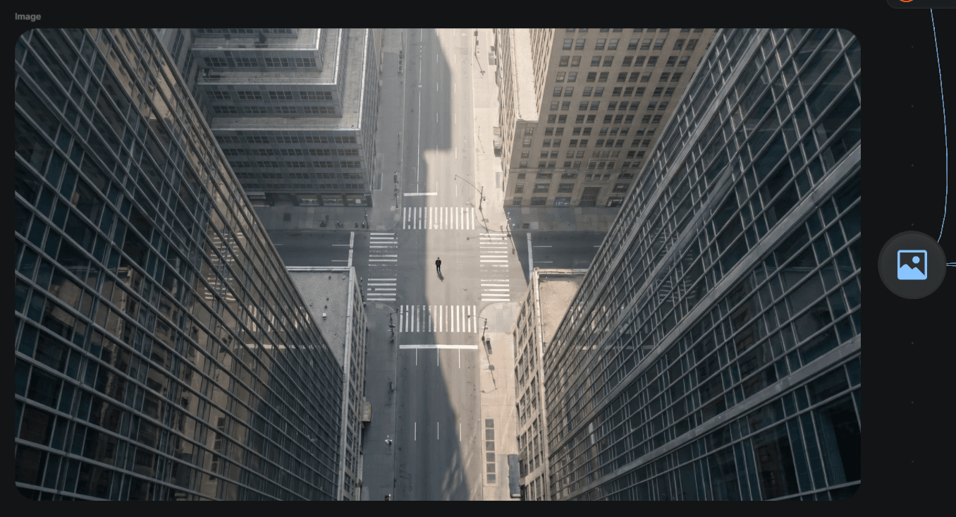 A lone figure at an empty midtown intersection, shot straight down